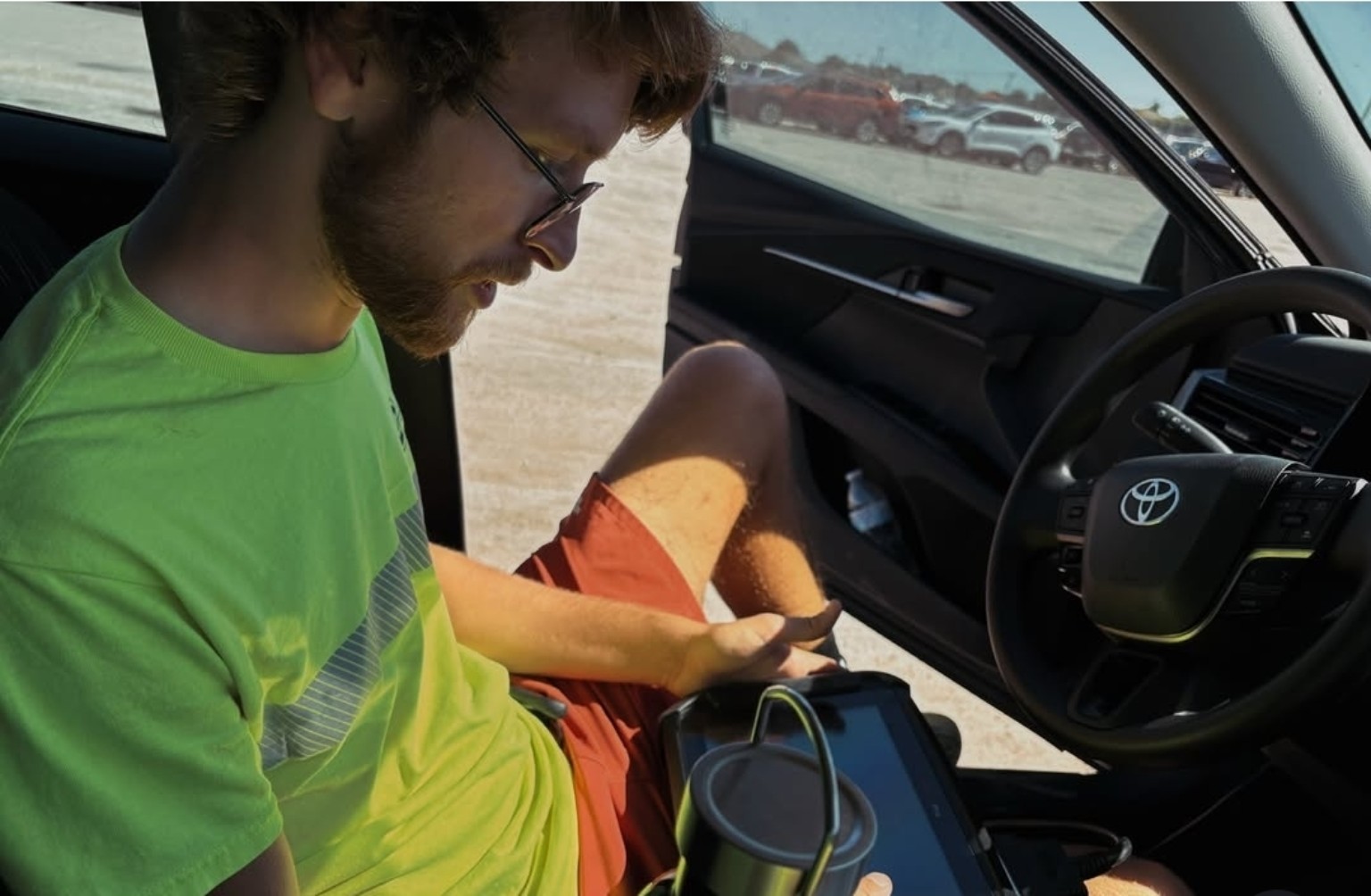 Cutting Edge technician using a programming tablet inside a Toyota