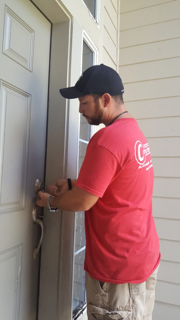 Locksmith working on a residential front door lock