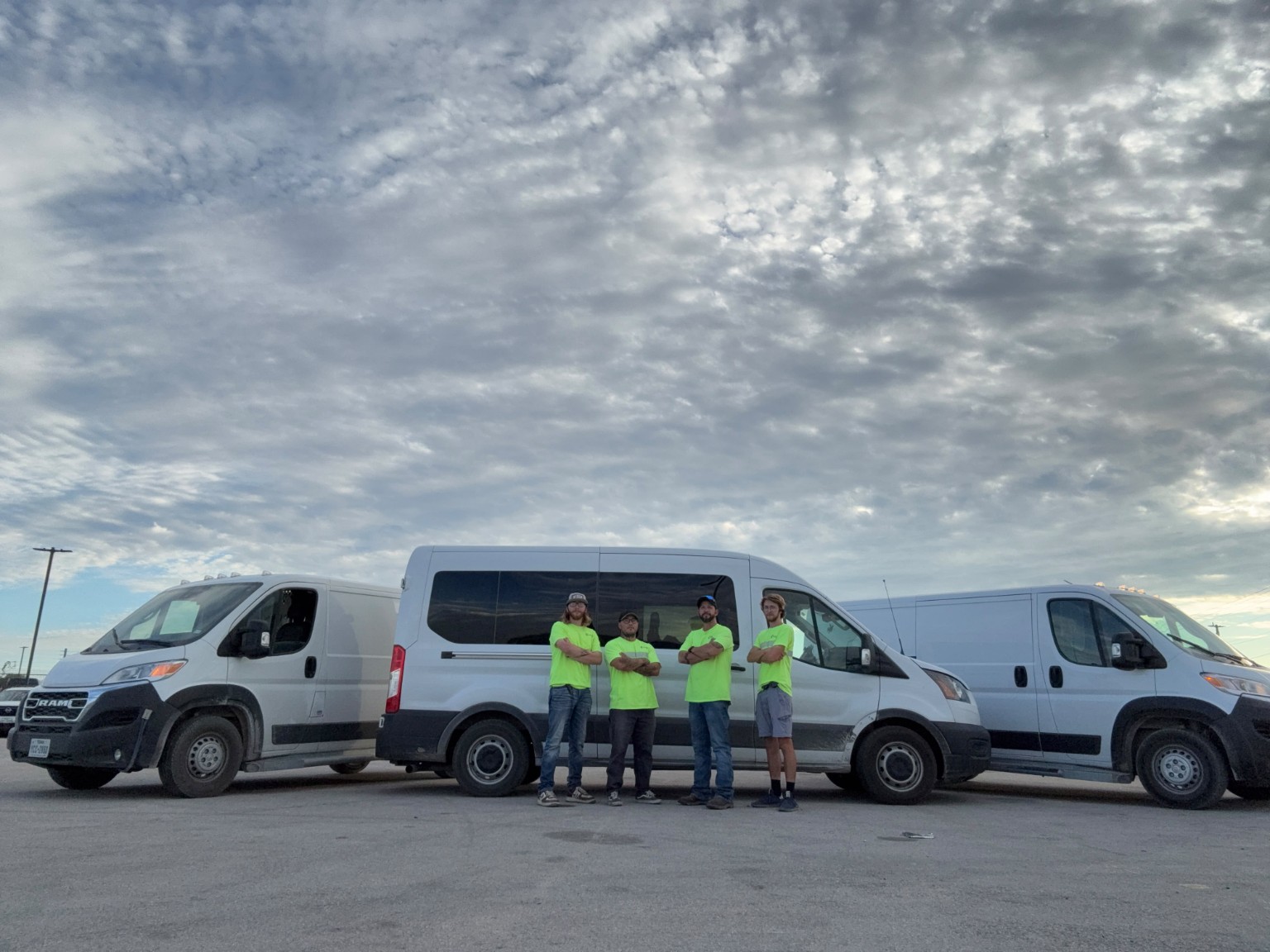 Cutting Edge Lock & Key team standing in front of three mobile service vans